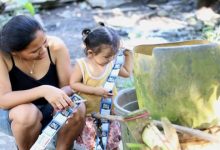 Mother and child holding packets