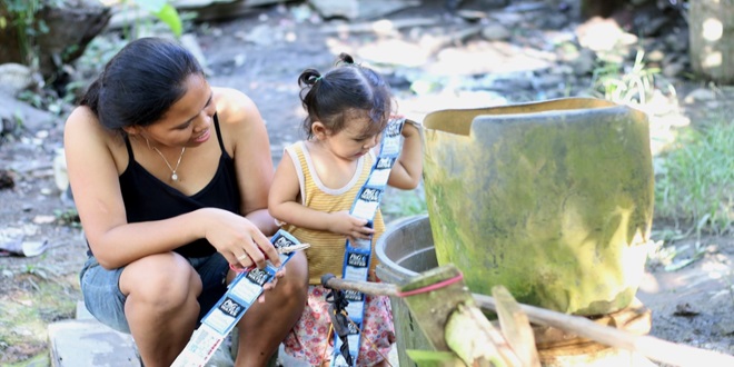 Mother and child holding packets