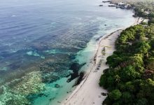 Patar Beach in Bolinao, Pangasinan, is a serene escape that boasts breathtaking rock formations and golden sands, providing a tranquil retreat for visitors_1