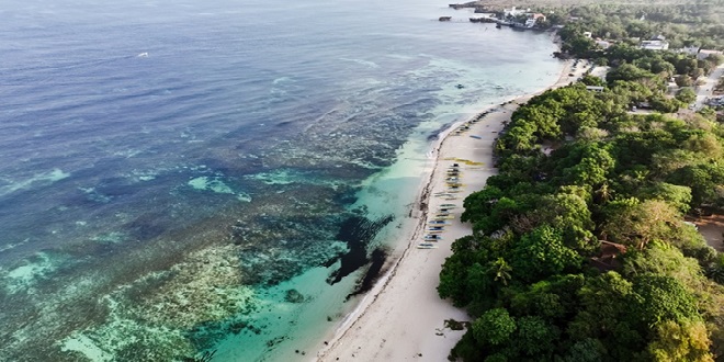 Patar Beach in Bolinao, Pangasinan, is a serene escape that boasts breathtaking rock formations and golden sands, providing a tranquil retreat for visitors_1